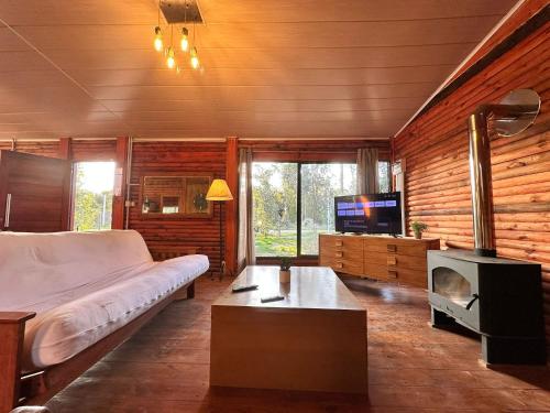 a bedroom with a bed and a tv in it at Macondo in Sauce de Portezuelo