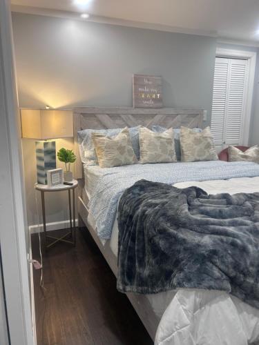 a bedroom with a large bed with a blanket on it at So cute so cozy in Elizabeth