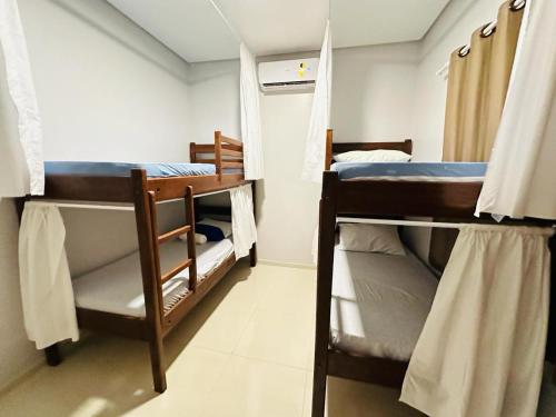 a small room with two bunk beds in it at Bela Casa Hostel in Ji-Paraná