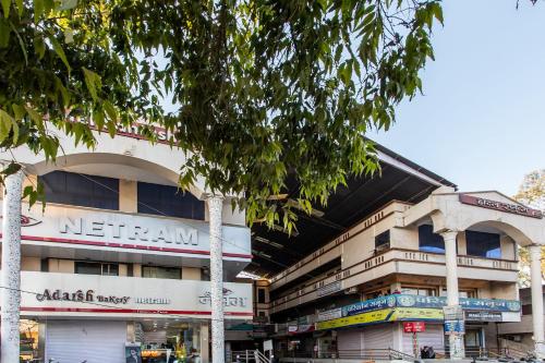 a building on a city street with a tree at Hotel O Santushti in Dewās