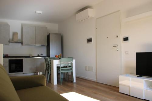 a living room and kitchen with a couch and a table at Flamingo Houses in Quartu Sant'Elena