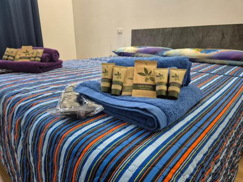 a bed with blankets and pillows on top of it at Flamingo Houses in Quartu Sant'Elena