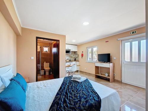 a bedroom with a bed and a living room at Cantinho da Lourdes e Tonito Nº 136193/AL in Miro