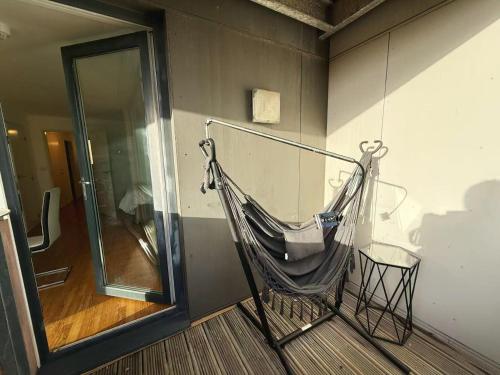 a hammock hanging on a wall in a room at City Center Balcony by the Universities in Manchester