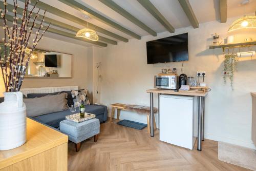 a living room with a couch and a table at Charming Welsh Cottage in Dolgellau - Snowdonia in Dolgellau