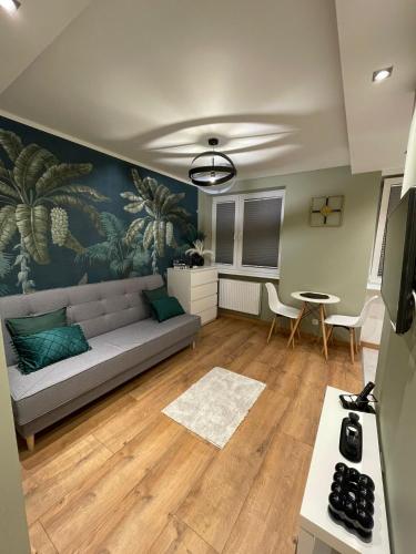 a living room with a couch and a table at Chill Apartament Gdynia in Gdynia