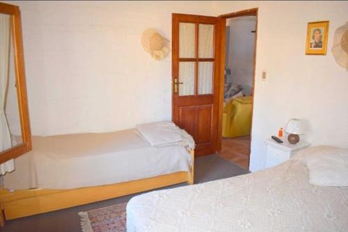 a hotel room with two beds and a door at Les y Hirondelles in Piriápolis