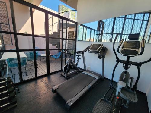 a gym with a treadmill and a bike in a room at NIU Modern Apartments near WTC & Condesa - Roma Sur in Mexico City
