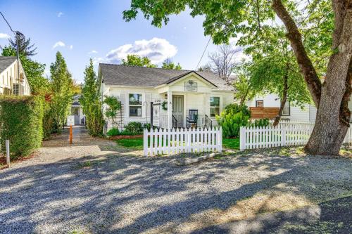 a white picket fence in front of a white house at C Street Cottages in Jacksonville