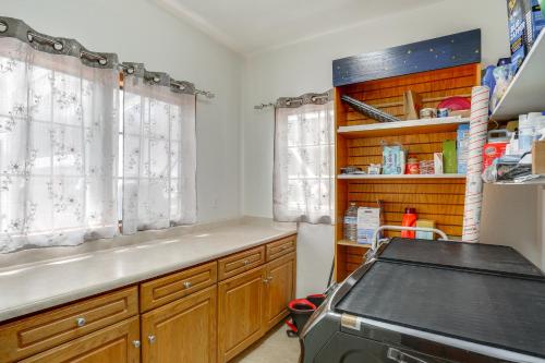 a kitchen with wooden cabinets and a counter top at 3 Mi to Sequoia Park Zoo Spacious Home with Sunroom in Rosewood
