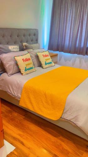 a bed with two pillows on top of it at Maxismile Haven in Southend-on-Sea