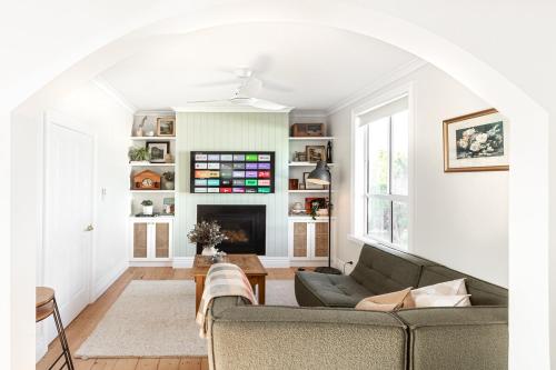 a living room with a couch and a fireplace at Koroit Street Cottage in Warrnambool
