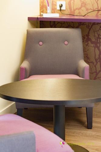 a table and a chair in a room at L'Hostellerie d'Acquigny in Acquigny