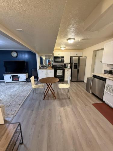 a kitchen with a table and chairs in a room at Affordable 2-bedroom basement in Clearfield in Clearfield