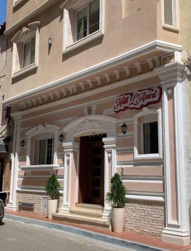 a building with two potted plants in front of it at Amirale in Oran