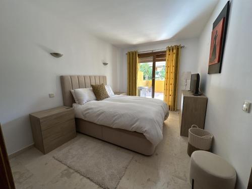 a bedroom with a bed and a television in it at Spacious ground floor apartment in Punta Prima