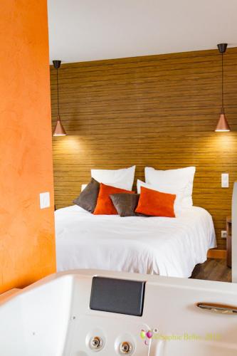 a bedroom with a bed and a bath tub at L'Hostellerie d'Acquigny in Acquigny