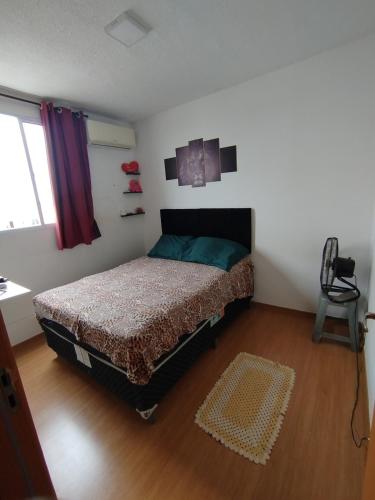 a bedroom with a bed in a room at Pinheiros in Várzea Grande