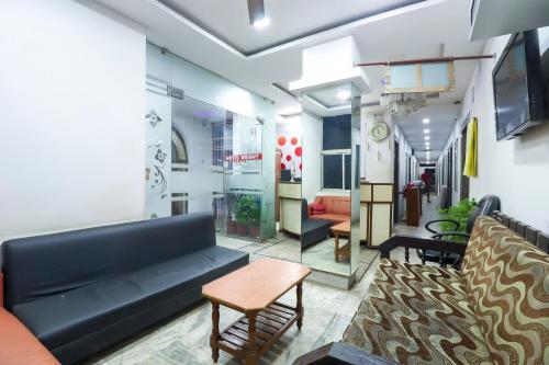 a living room with a couch and a table at Hotel O Bright in Jamshedpur