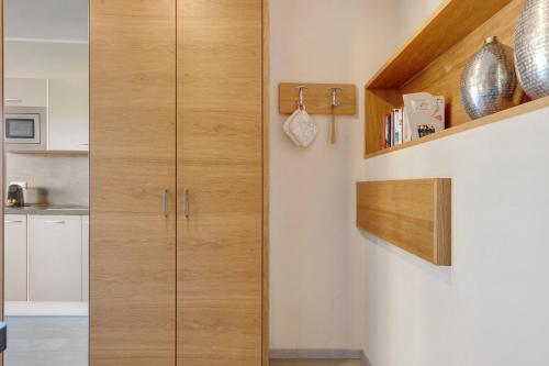 a kitchen with wooden cabinets in a room at Landhaus Antonius Eppan in Appiano sulla Strada del Vino