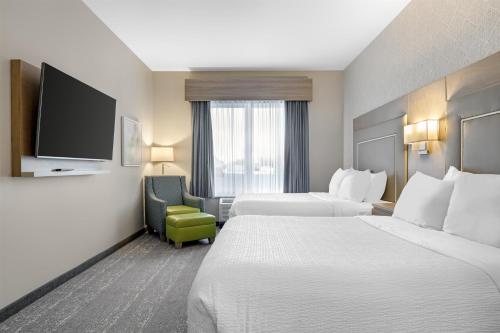 a hotel room with two beds and a flat screen tv at Best Western Plus Dartmouth Hotel & Suites in Halifax