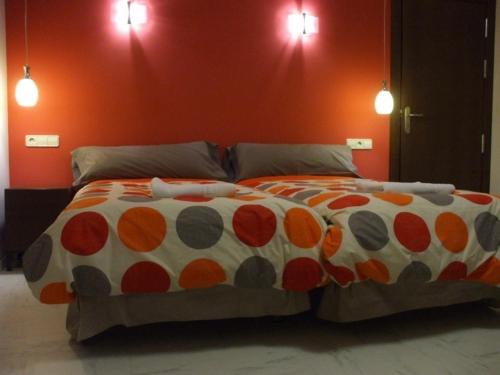 a bed with a polka dotted comforter in a bedroom at Allucant - Gallocanta in Gallocanta