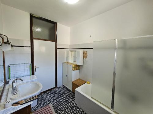 a bathroom with a shower and a sink and a tub at Riverside San Pellegrino in San Pellegrino Terme