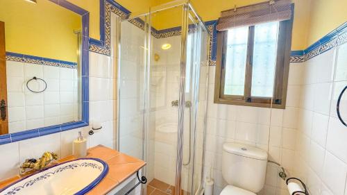a bathroom with a shower and a sink and a toilet at Villa Florencia in Frigiliana
