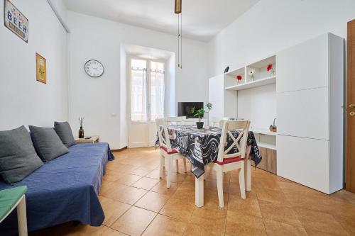 a living room with a couch and a table with chairs at Casabaffo in Piombino
