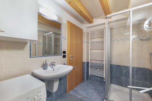 a bathroom with a sink and a shower at Apartment Latemar Casa Alma in Tesero