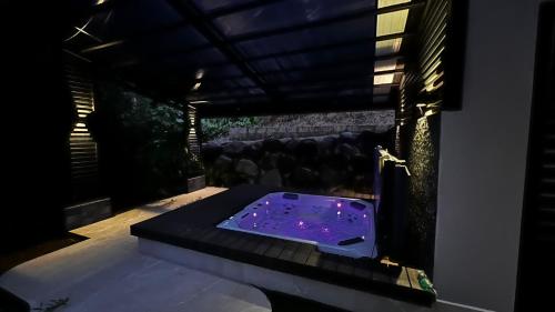 a jacuzzi tub in a room with a window at Quebrada Honda GlamShack in Pueblo Nuevo