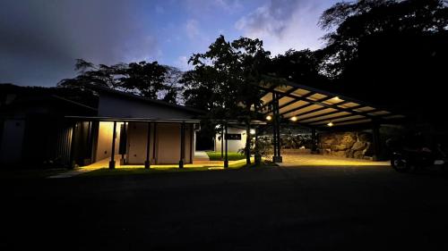 a barn with a lit up garage at night at Quebrada Honda GlamShack in Pueblo Nuevo