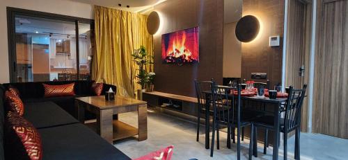 a living room with a couch and a table with a fireplace at Cosy Maarif Arena by Viva Stay in Maarif