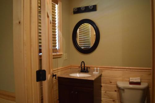 a bathroom with a sink and a mirror on the wall at White River Landing in Calico Rock