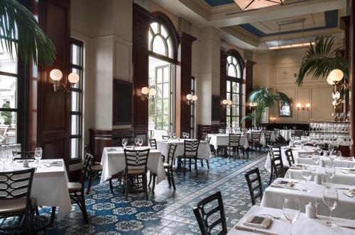 a restaurant with white tables and chairs and windows at The Venetian® Resort Las Vegas in Las Vegas