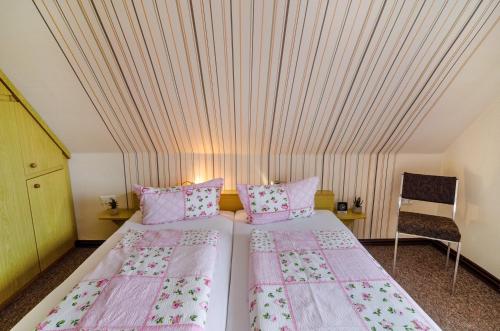 two beds in a room with a ceiling at Ferienwohnung Karin in Marienhafe