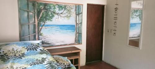 a bedroom with a window with a view of the ocean at Chalet La Gran Familia in San Bernardo