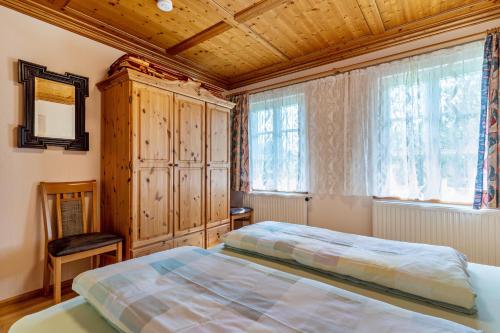 a bedroom with a bed and a wooden ceiling at Ferienhaus Vollmer in Nordrach