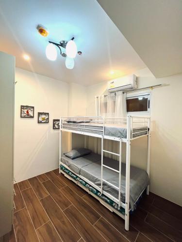 a bunk bed in a room with a ceiling at 2br Unit in Matina Enclaves Davao in Davao City