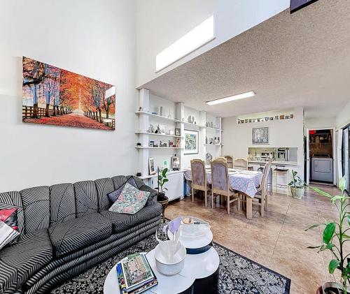 a living room with a couch and a table at 1BR in Shared Miami Home Pool Lake & Tennis in Fountainbleau