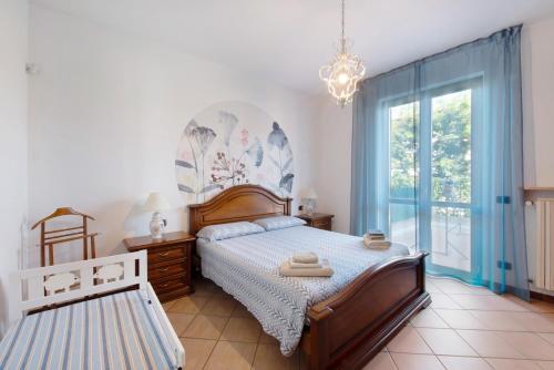 a bedroom with a bed and a large window at Casa Elli in Osio Sotto