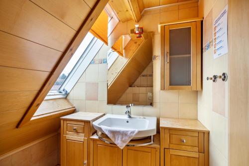 a bathroom with a sink and a skylight at Ferienwohnung Haselgrund in Kurort Steinbach-Hallenberg