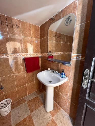 a bathroom with a sink and a mirror at Wave Stay Hostel - Sea View in Agadir