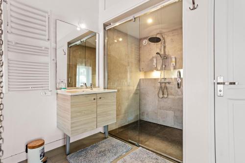 a bathroom with a sink and a shower at Mas J des Sens - petit dej compris in Le Val