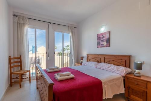 a bedroom with a large bed with a red blanket at El Verger in Molinell