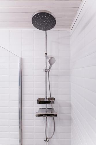 a shower in a bathroom with a shower head at Zegzug Noszvaj in Noszvaj