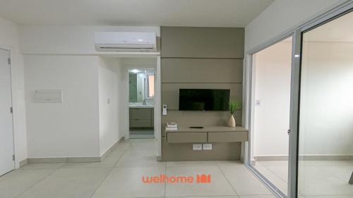 a living room with a tv and a window at Apartamento em Bauru com Vista para Montanha in Bauru