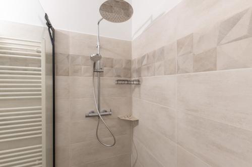 a shower with a shower head in a bathroom at Maison de village - l'Externat in Laurac-en-Vivarais