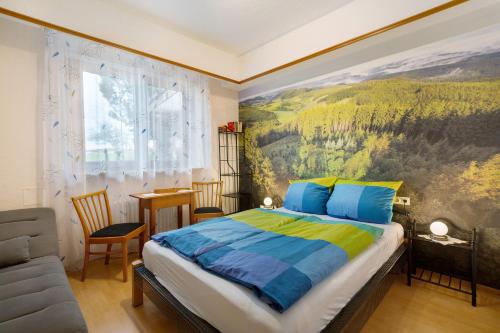 a bedroom with a bed and a painting on the wall at Haus Bührer in Freiamt