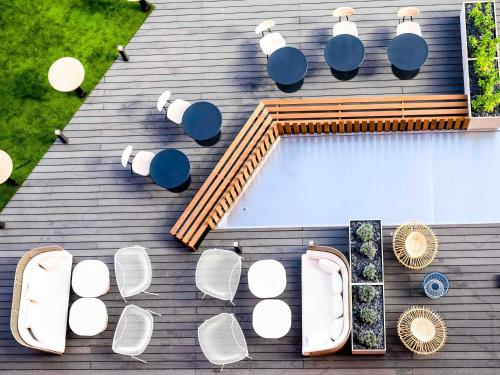 an overhead view of a roof with white chairs and lights at Novotel Saint-Étienne Centre Gare Châteaucreux in Saint-Étienne